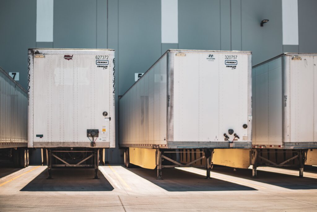 project-4 A row of freight trailers parked at a commercial loading dock, emphasizing transportation and logistics.